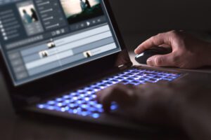 hands working on a laptop running professional video software