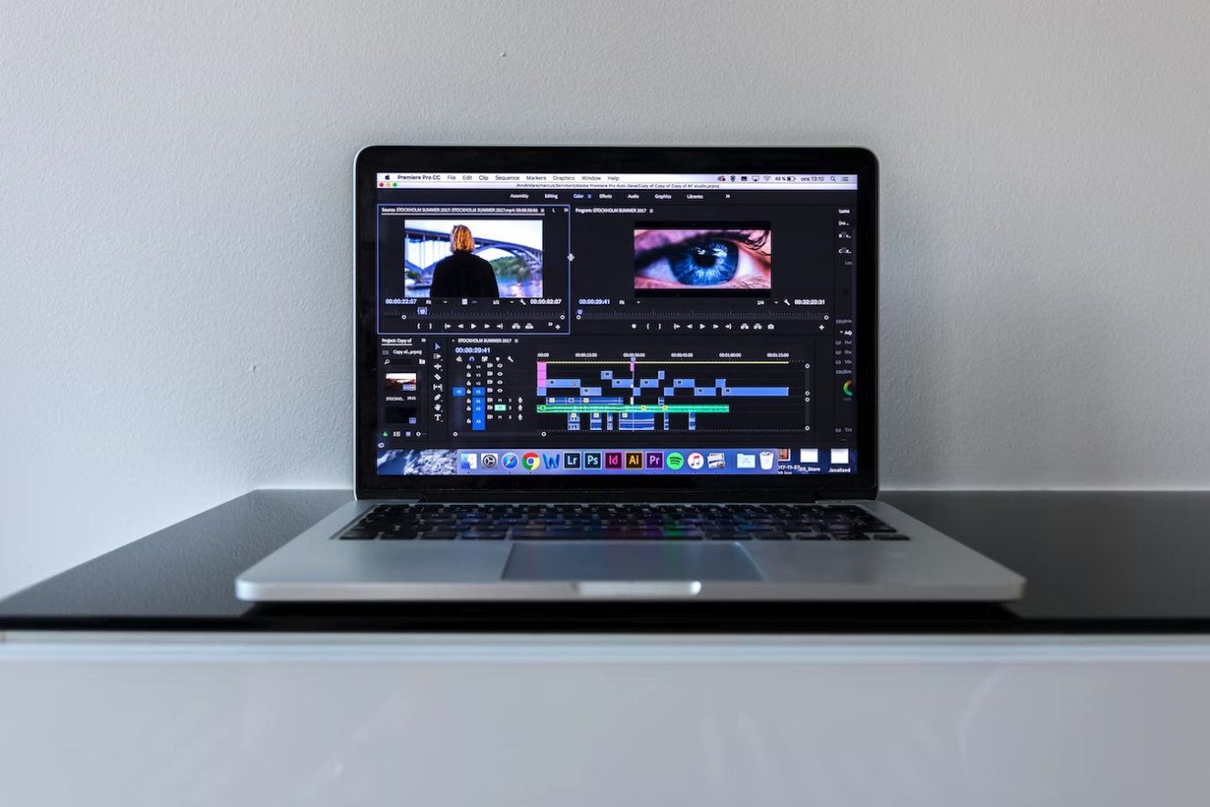 laptop on a desk with editing software on the screen