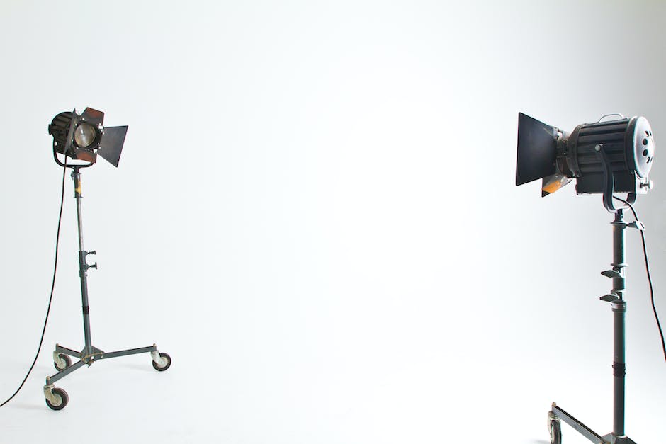 two film lights on rolling stands in an all white studio