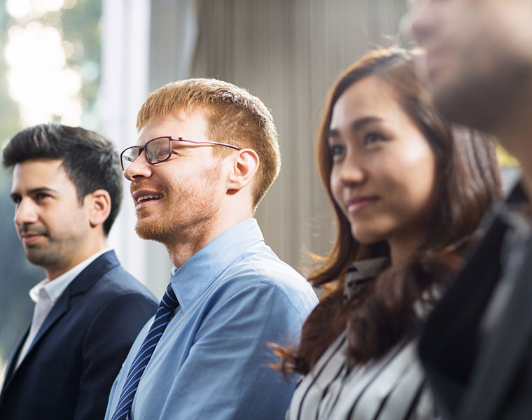 audience members at a business conference smiling