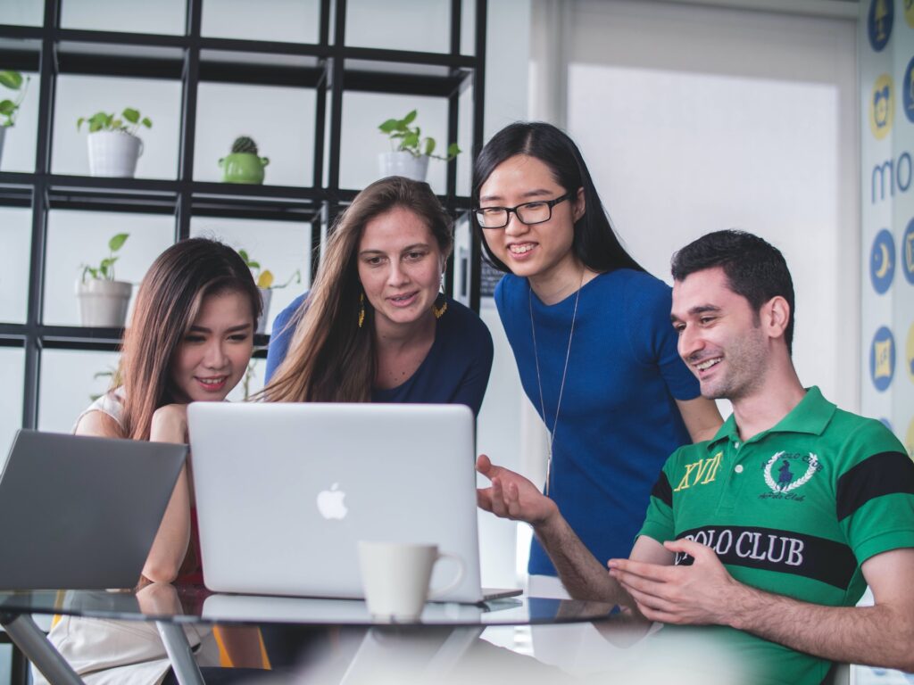 Four people watching a video on a mac