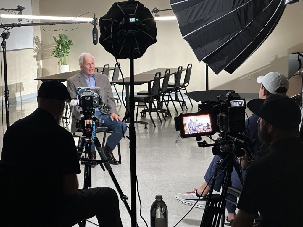 Corporate video production interview being filmed in a professional studio