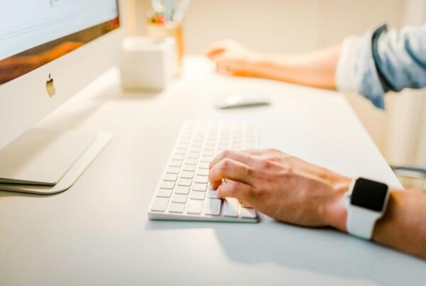 Marketer working on a desktop computer to implement strategies to drive traffic to a website