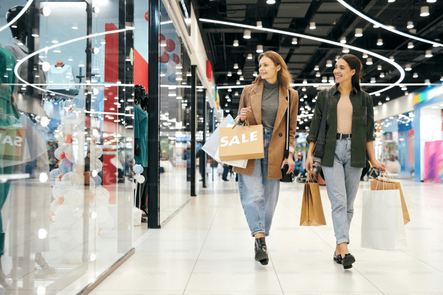 Two women shoppers looking at a retail display