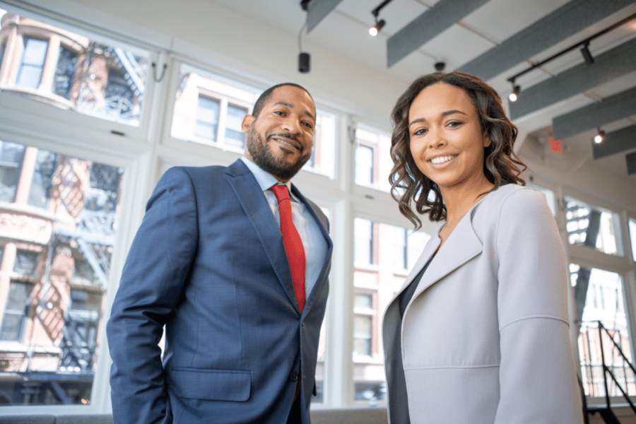A man and woman smiling into the camera