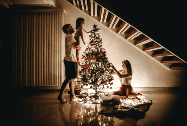A family next to a decorated Christmas tree