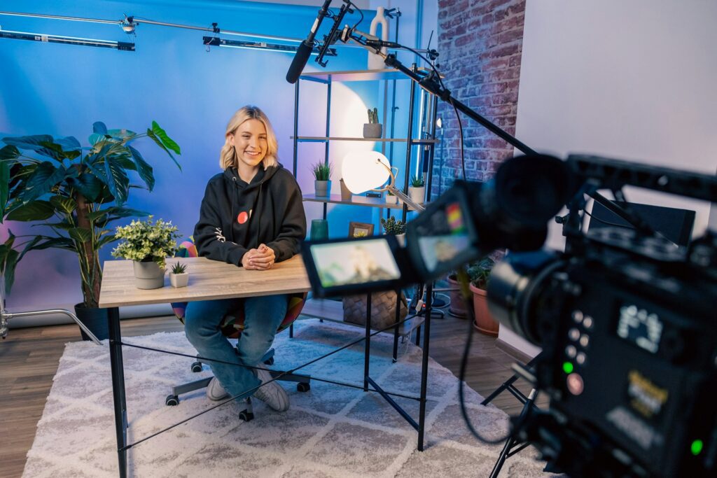 Woman at a desk recording video content to improve customer engagement