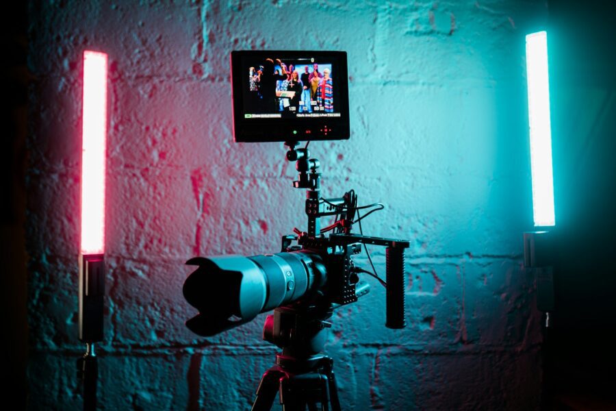 A camera in front of a wall recording a video