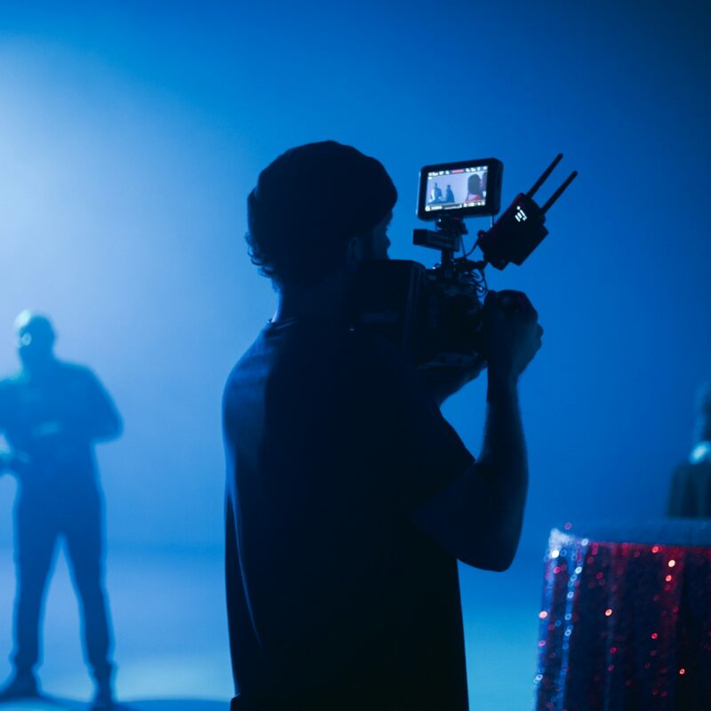 Man filming a video ad on set