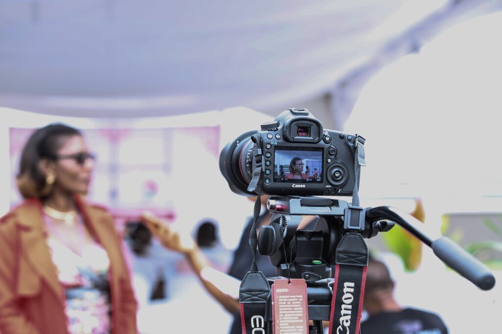 A person is standing in front of a camera giving an interview